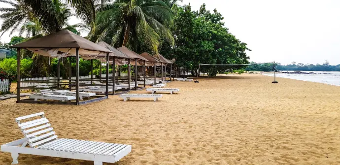 a beach with umbrellas and chairs